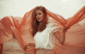 Beautiful red-haired girl with a cape