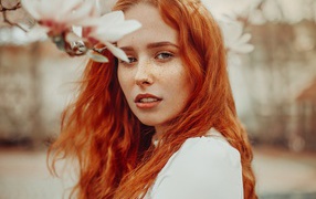 Beautiful red-haired girl with freckles on her face