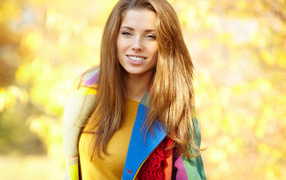 Beautiful smiling brown-haired woman in a coat
