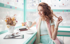 Красивая улыбающаяся девушка шатенка с чашкой кофе