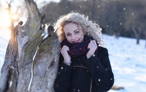 Голубоглазая блондинка у сухого дерева зимой