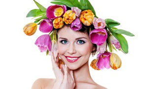 Blue-eyed smiling girl with a wreath of tulips on her head