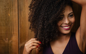 Curly-haired dark-haired girl with a beautiful smile