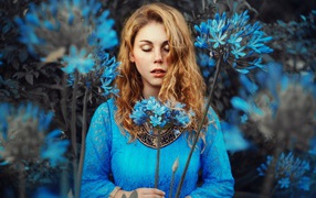 Dreamy girl with blue flowers