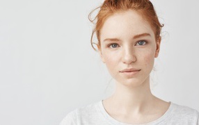 Red-haired girl on a gray background