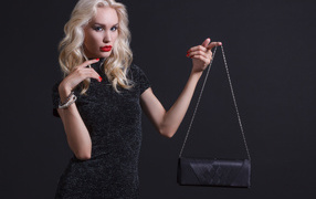 Stylish blonde with a black handbag
