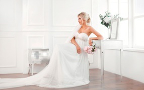 Young blonde in a beautiful white wedding dress