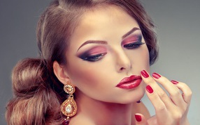 Young girl in bright make-up and red nails