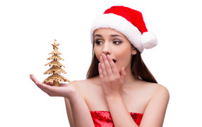 Surprised girl Snow Maiden with a small Christmas tree in her hand on a white background