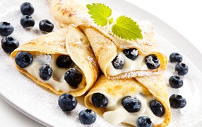Appetizing pancakes with cottage cheese and blueberries on Shrovetide