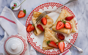 Appetizing pancakes with strawberries on Pancake week