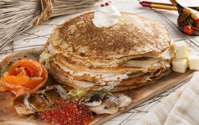 Delicious pancakes with fish and red caviar treats for the holiday Maslenitsa