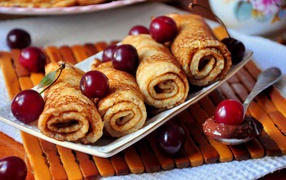 Thin pancakes with cherries treat for the holiday Maslenitsa 2019