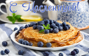 Thin pancakes with powdered sugar and blueberries for the holiday Maslenitsa 2019