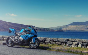 Blue BMW S1000 motorcycle against the background of water
