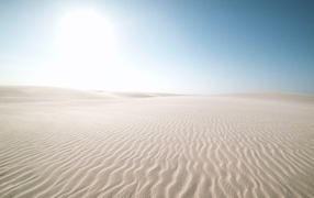 White sand in the desert against the blue sky