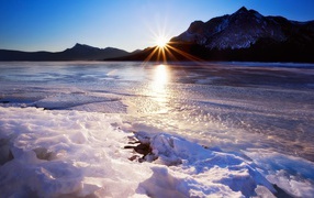 Лед тает в горном озере от тепла весеннего солнца