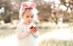 A cute little girl eating strawberries