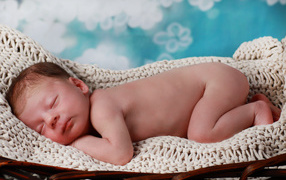 A small sleeping infant in the cradle
