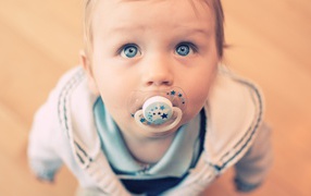 Blue-eyed little boy with a pacifier