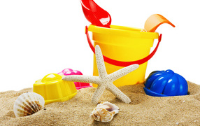 Children's toys with seashells on the sand