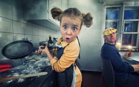 Funny little girl cooks pancakes