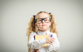 Girl schoolgirl with glasses with books