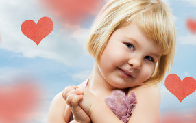 Little cute girl on a background of red hearts