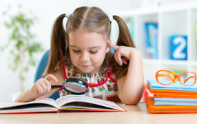Little girl schoolgirl with a book