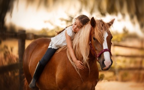 Little girl sitting on a horse