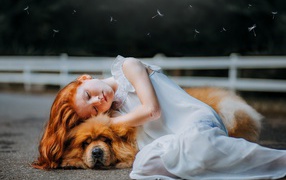 Маленькая рыжеволосая девушка в белом платье с собакой