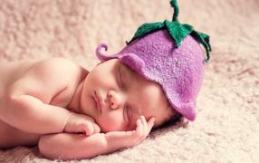 Sleeping baby in a hat in the form of a flower