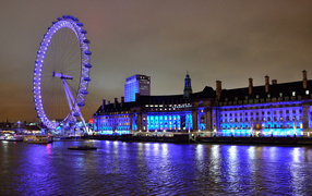 Ferris wheel by the water at night, London