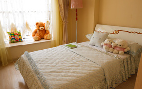 Children's room with a large bed and soft toys