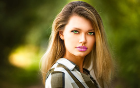 Gentle green-eyed girl blonde with painted lips