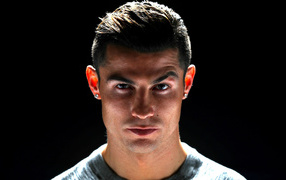Handsome football player Cristiano Ronaldo photo on black background