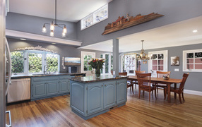 Large beautiful kitchen in gray with a wooden table