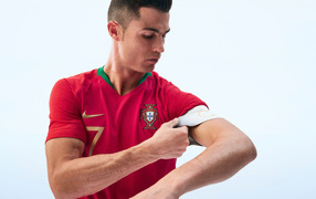 Popular football player Cristiano Ronaldo corrects his uniform