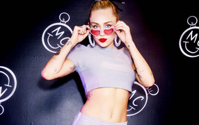 Popular singer Miley Cyrus wearing glasses