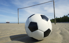 Soccer ball on the sand at the beach