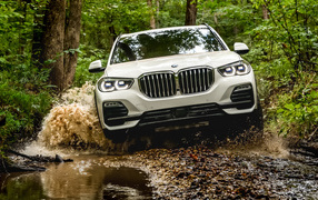 The 2018 BMW X5 XDrive40i SUV rides on water in the forest