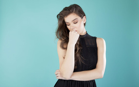 Young popular actress Hayley Steinfield, photo on a blue background