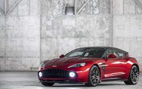 Red car Aston Martin Vanquish, 2019 on the background of a gray wall