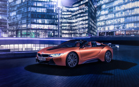 Дорогой оранжевый автомобиль BMW i8 на фоне здания