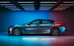 Серебристый автомобиль BMW M850i,  2019 года вид сбоку