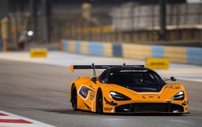 Orange sports car McLaren 720S GT3 on the race track