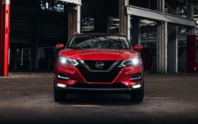 Red car Nissan Rogue front view