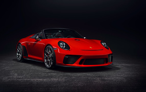 Red Porsche 911 convertible on a gray background