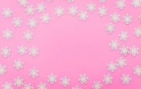 A lot of white snowflakes on a pink background