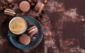 A cup of coffee with chocolate macaroons on the table